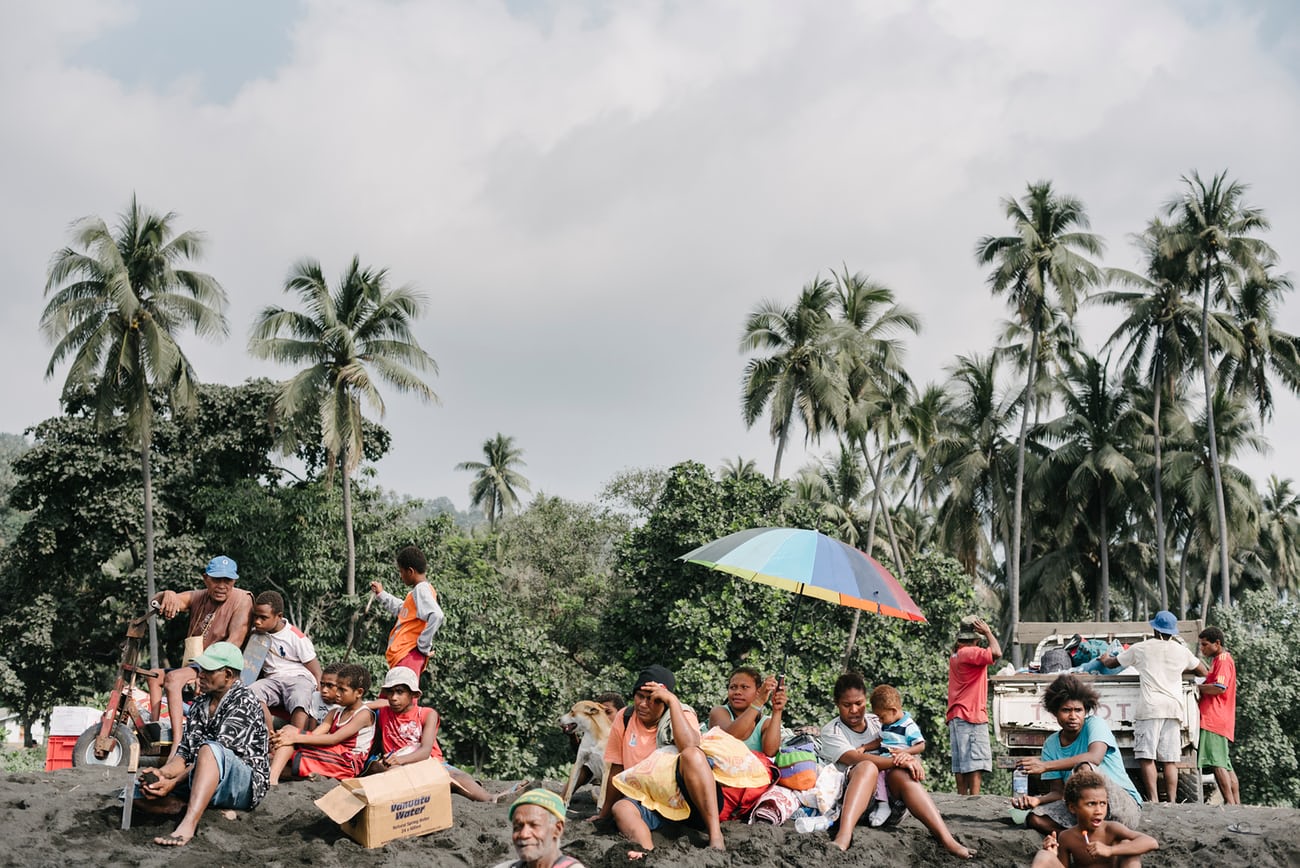 Residents from nearby villages gather with their belongings on beach near Lone, West Ambae awaiting evacuation to Santo. Photograph: Alana Holmberg for the Guardian