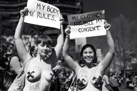 Two girls protest the policing of women's bodies.