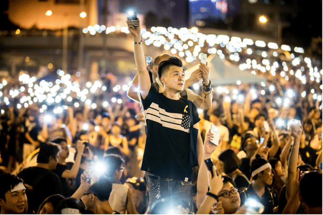 Mathew Lynn: 01 October 2014, Admiralty, Hong Kong.  'Occupy Hong Kong With Peace And Love' / 'Umbrella Revolution' protestors wave mobile phone LED's while singing in unity beside government buildings in Hong Kong. Protests began after the Standing Committee of the National People's Congress (NPCSC) came to a decision regarding proposed reforms to the Hong Kong electoral system.'